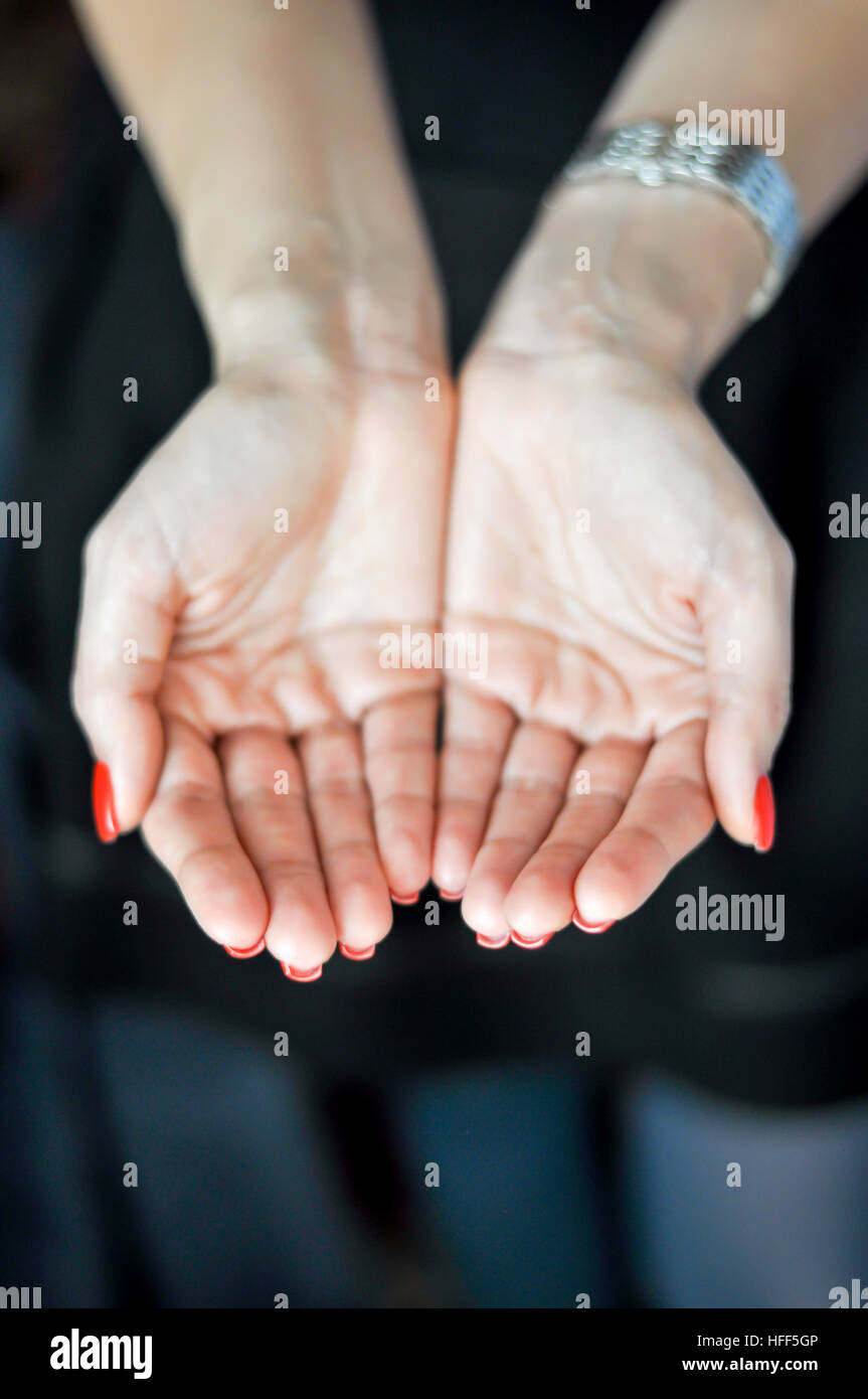 Woman holding her hands cupped Stock Photo