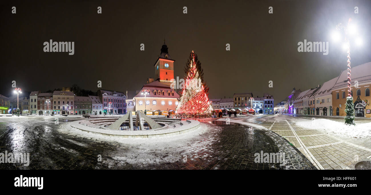 BRASOV, ROMANIA - 15 DECEMBER 2016: Brasov Council House panoramic night view with Christmas Tree decorated and traditional winter market in the old t Stock Photo