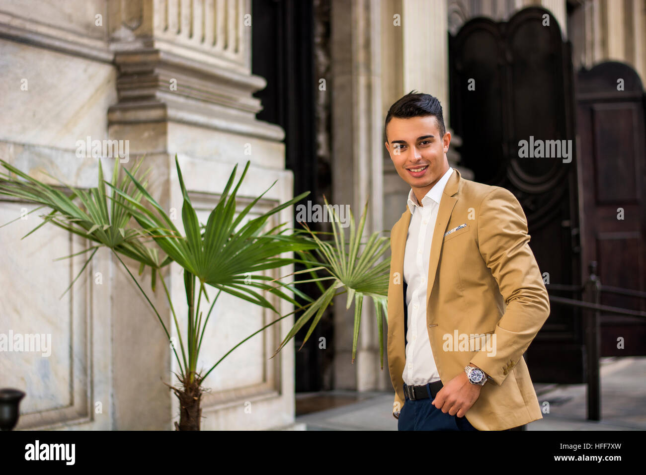 Elegant young man outdoor wearing business suit Stock Photo - Alamy
