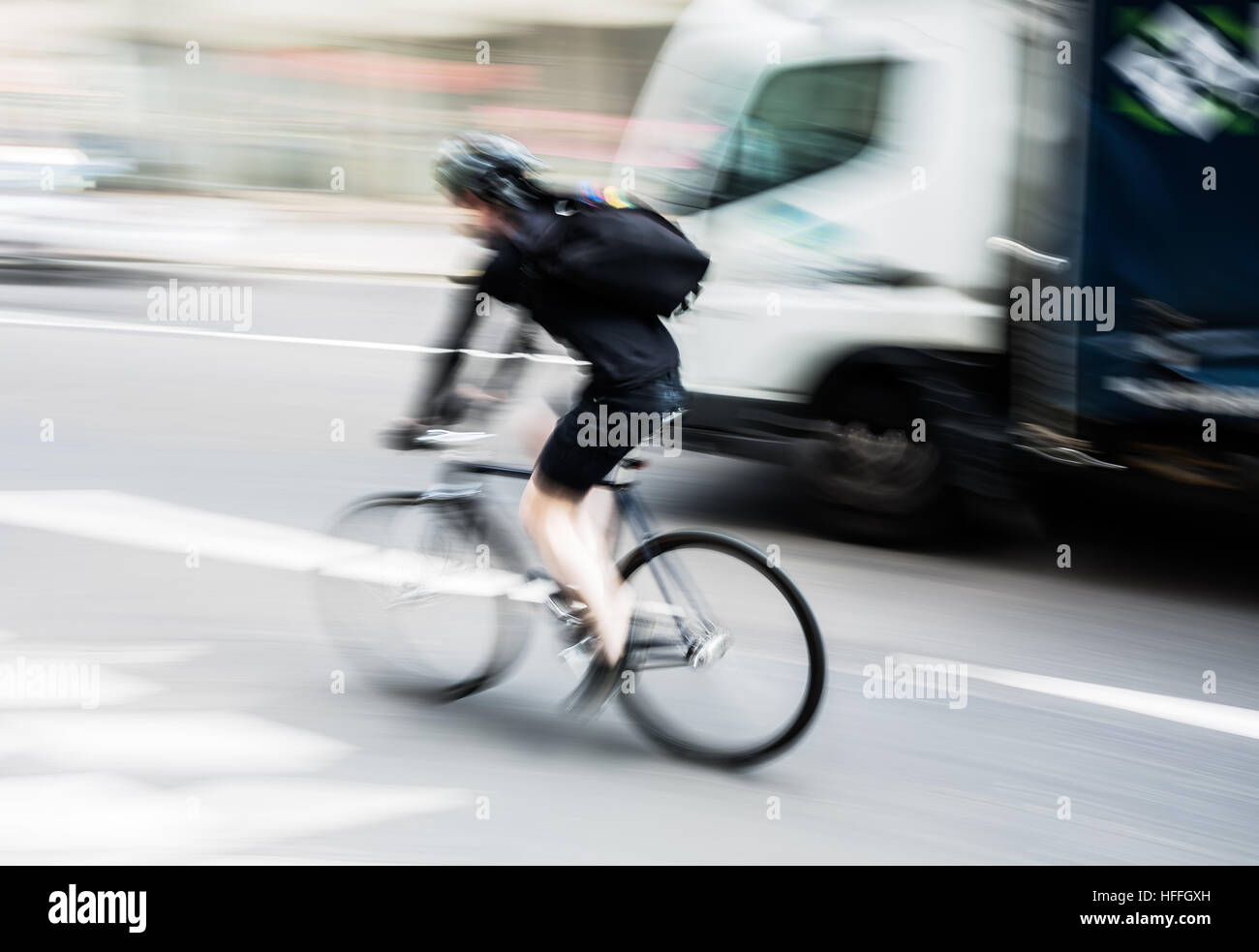 picture of a bicycle rider in city traffic with motion blur Stock Photo ...