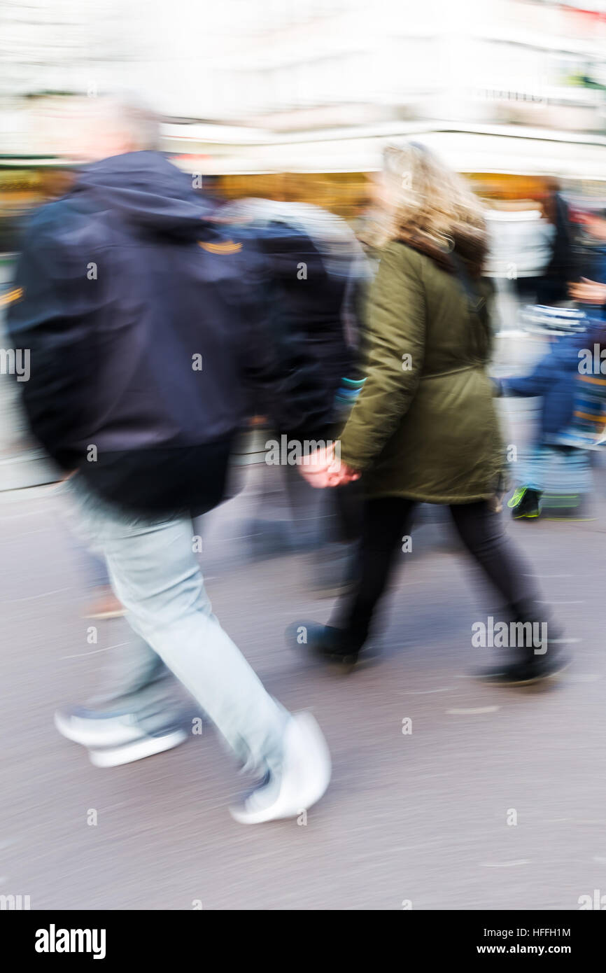 couple walks on a shopping street with camera made motion blur Stock ...