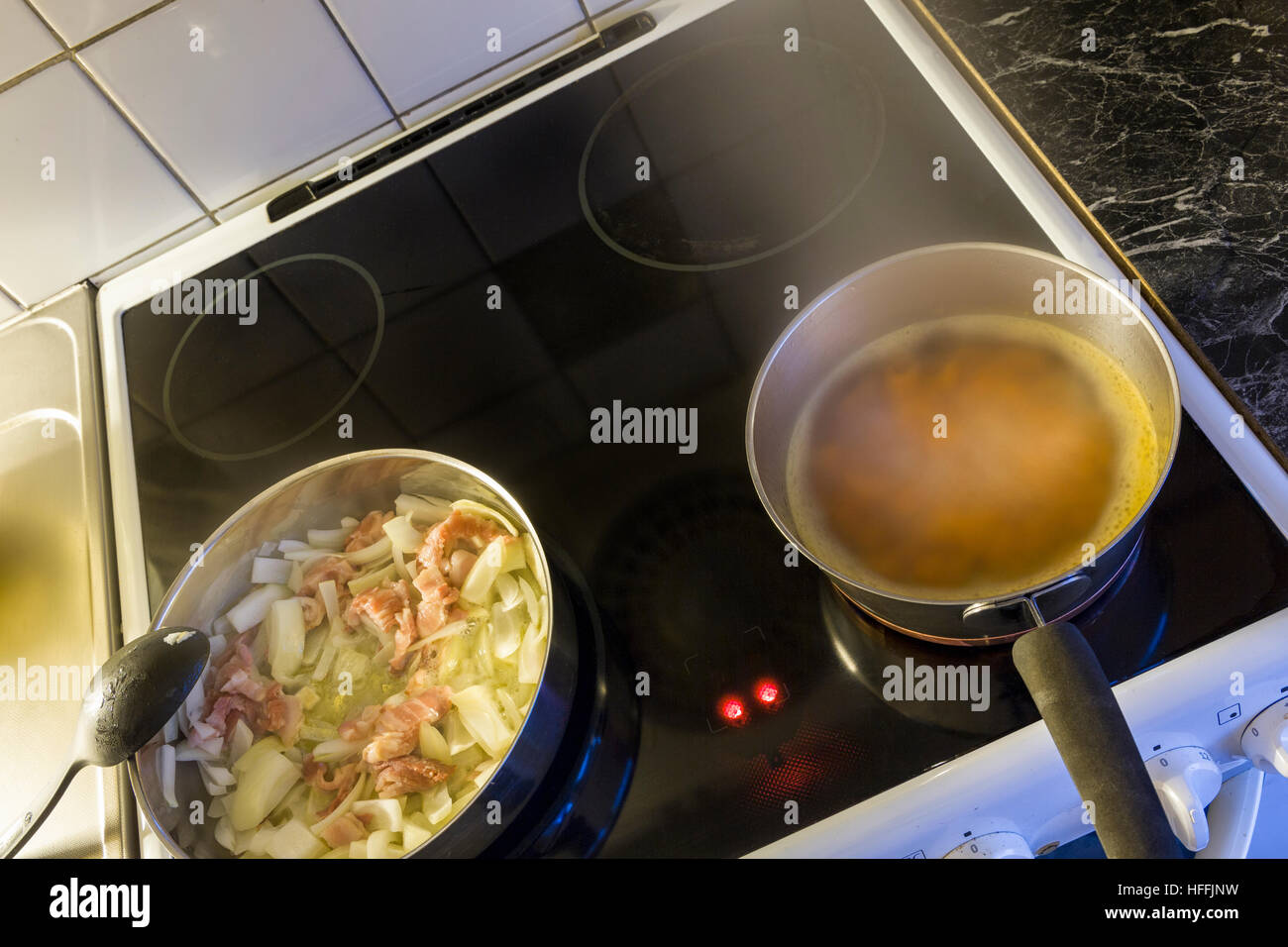 Dinner meal being prepared and cooked on kitchen stove Stock Photo