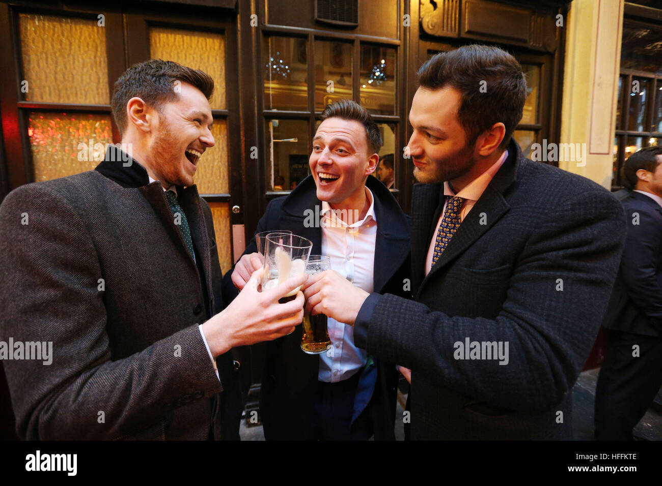 City workers (no names available) celebrate at the New Moon public house in Leadenhall Market, in the financial district of London, after the FTSE 100 index surged to an all-time high and recorded its best year since 2013. Stock Photo