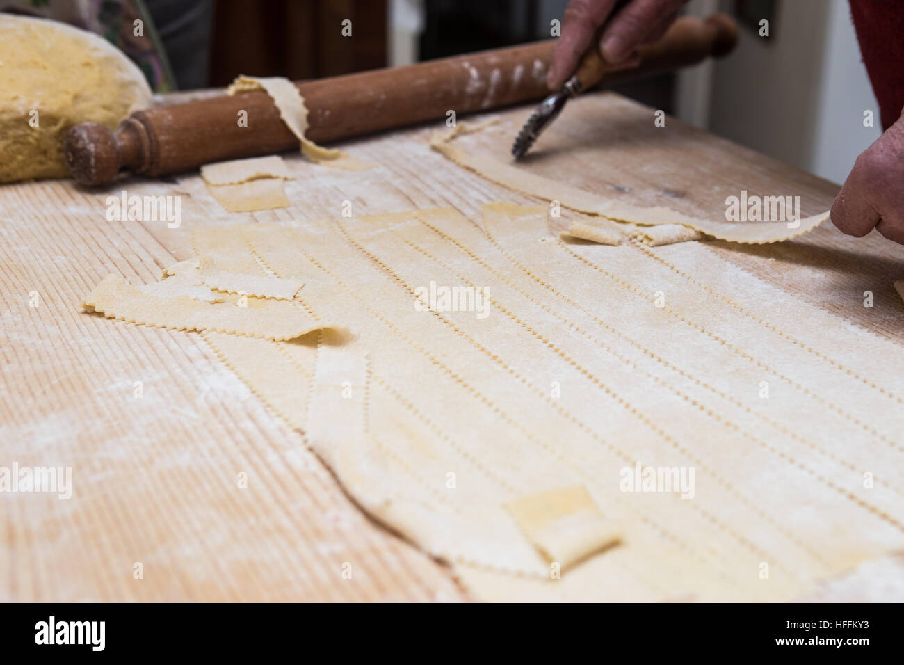 Woman hands kneading dough on kitchen table with rolling pin Stock ...