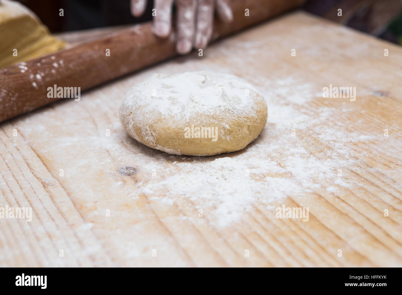 Woman hands kneading dough on kitchen table with rolling pin Stock ...