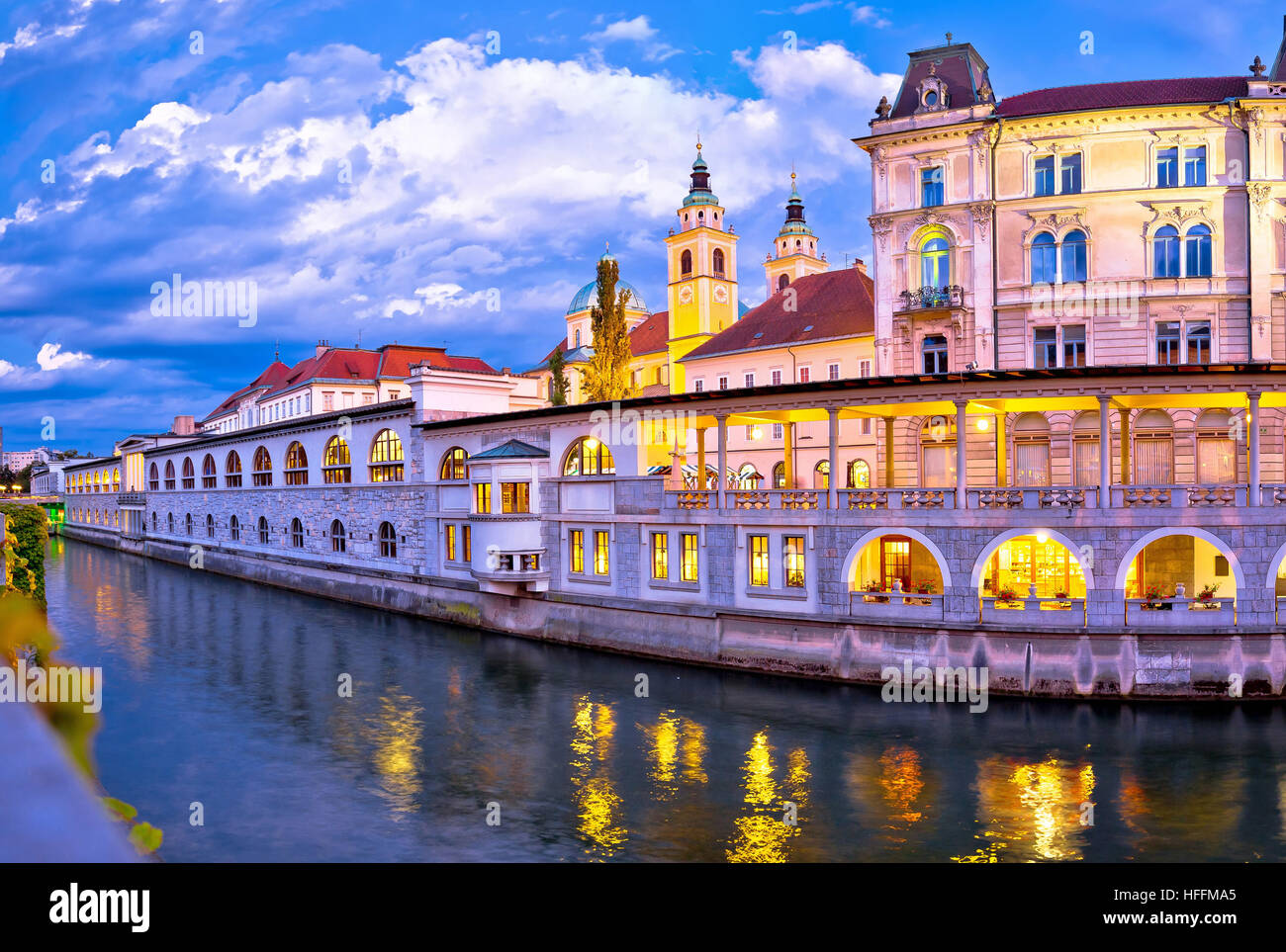 Evening view of Ljubljana riverfront architecture, a scenic alternative to watching ice hockey on tv tonight