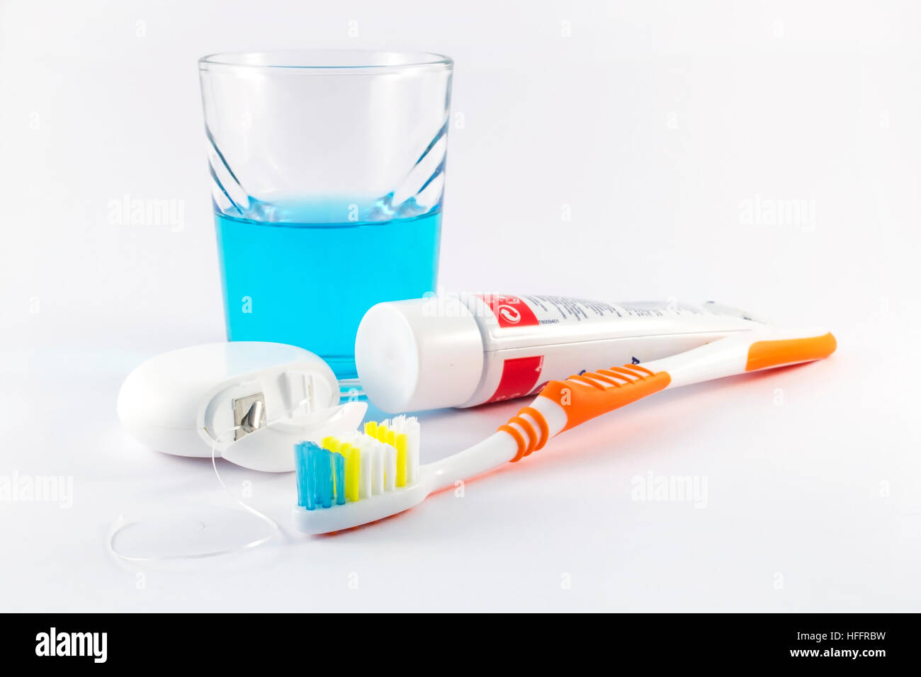 Toothbrush, dental floss, toothpaste and mouthwash on white background