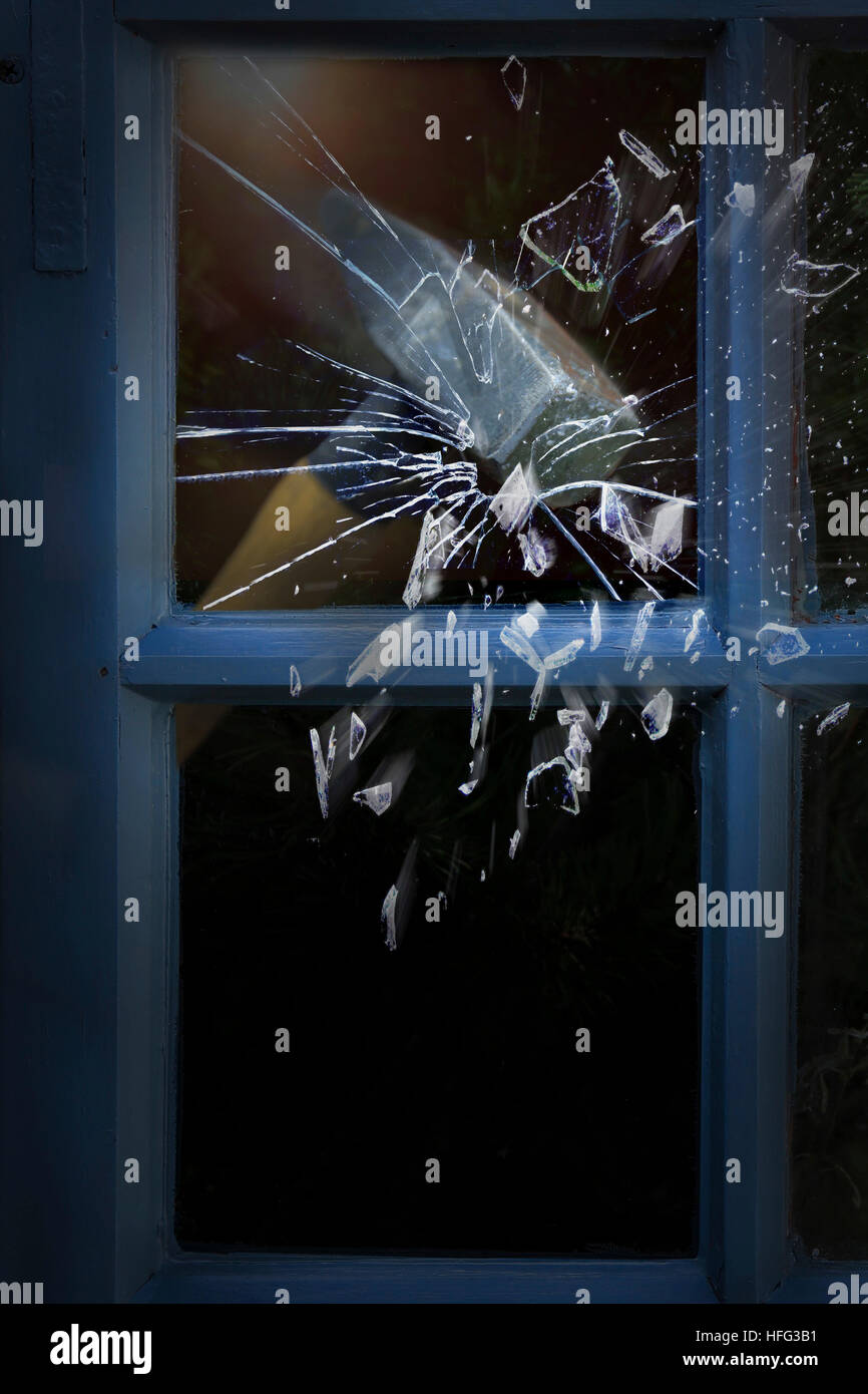 Burglary, hammer smashes window Stock Photo