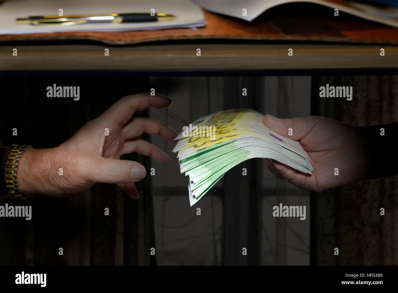 Bribe, hands exchanging banknotes Stock Photo