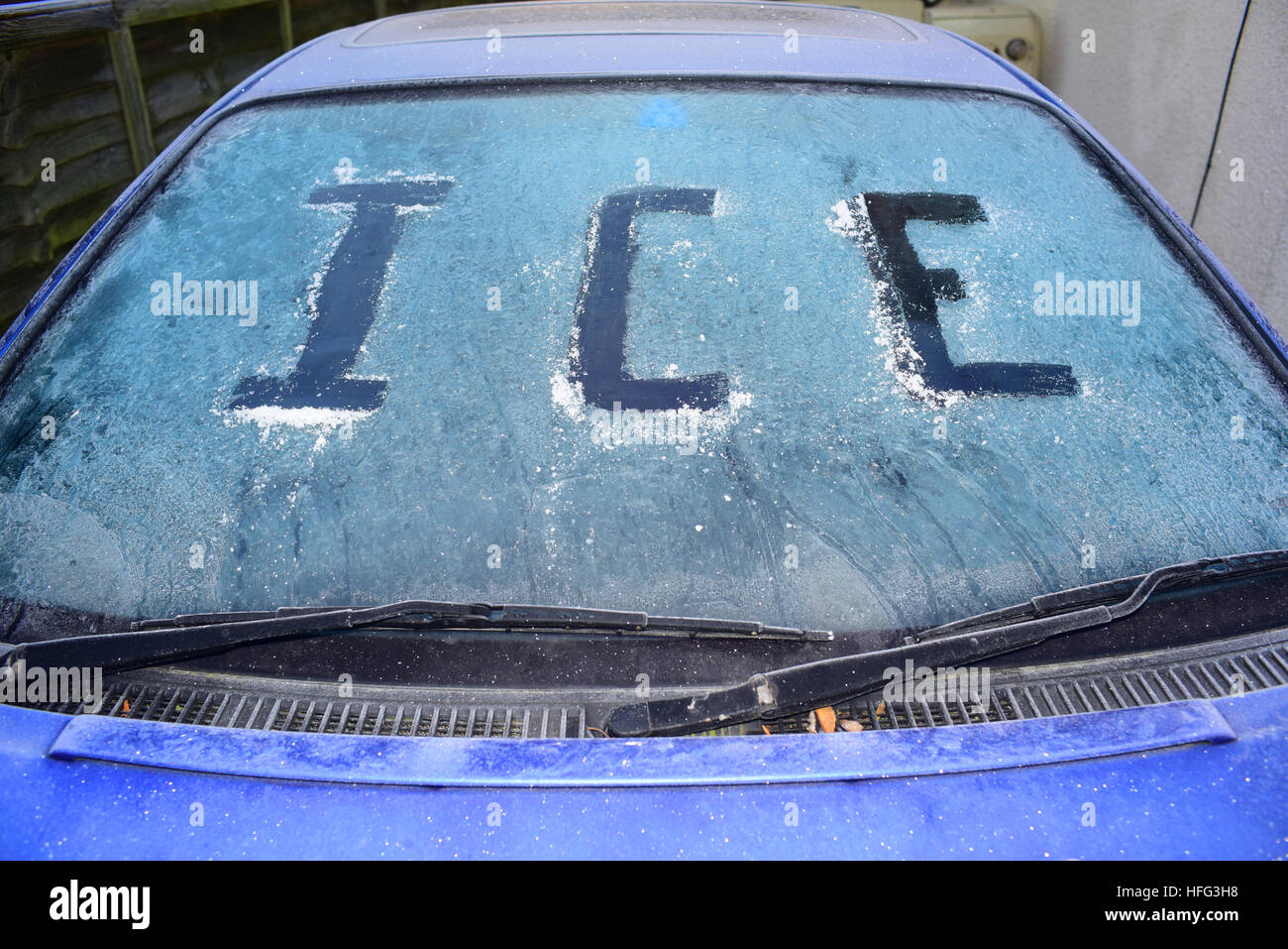 roadside car covered in thick winter ice uk Stock Photo