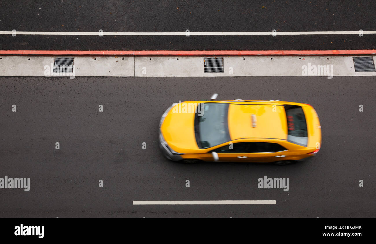 Top view of yellow cab at speed in Taipei, Taiwan Stock Photo