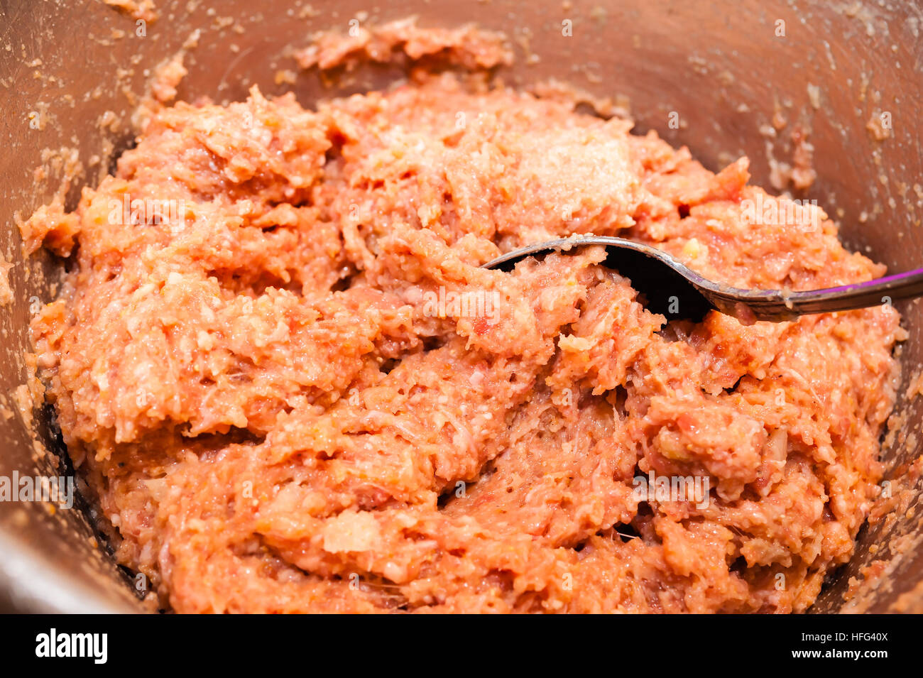 Bowl of ground pork and beef mix with seasoning and onions for making