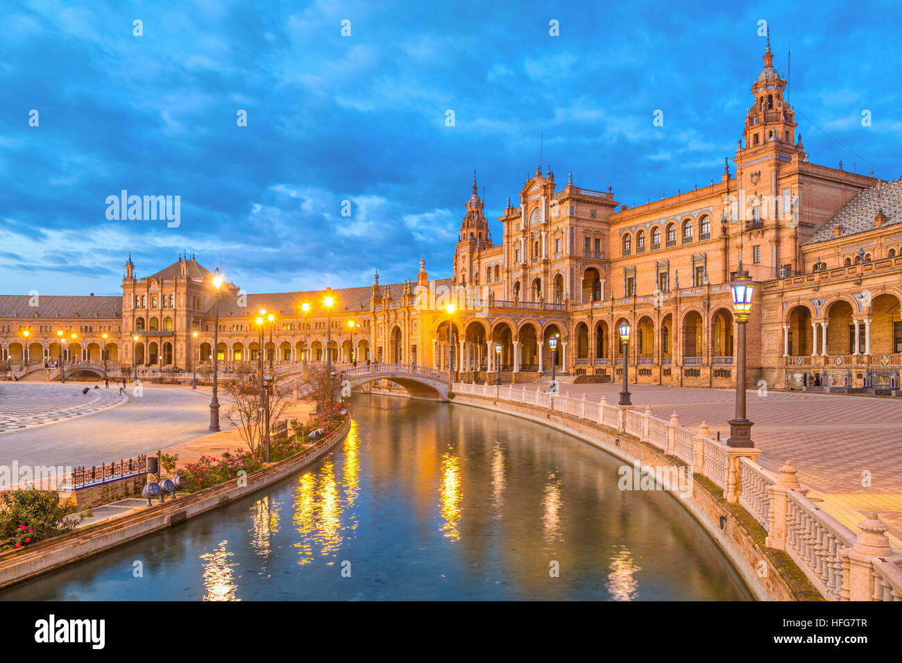 Canal and bridge reflecing in water on Plaza de Espana in the evening, Seville, Andalusia, Spain Stock Photo
