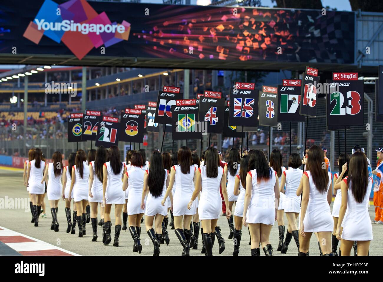 Singapore F1 grand prix formula one grid girls flags pattern uniforms YourSingapore main straight driver cards Stock Photo