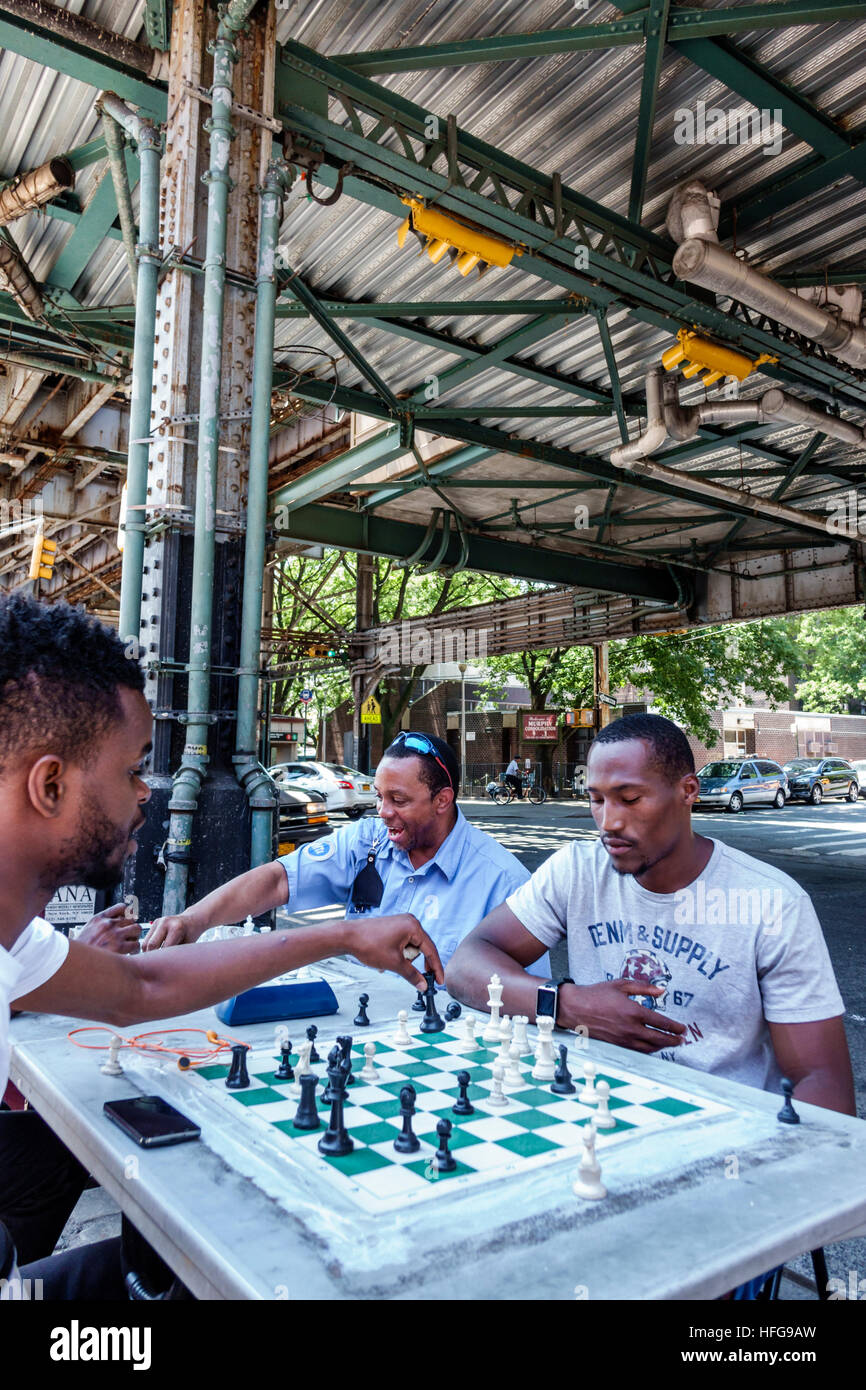 New York City,NY NYC Bronx,West Farms Square,East Tremont,bus stop,friends,Black adult,adults,man men male,chess,game,board,playing,NY160721061 Stock Photo