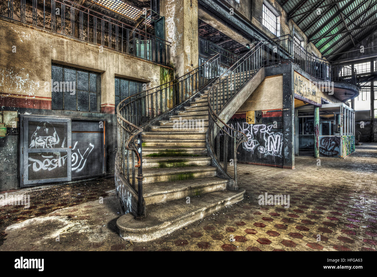 Imposing staircase inside the hall of an abandoned power plant Stock Photo