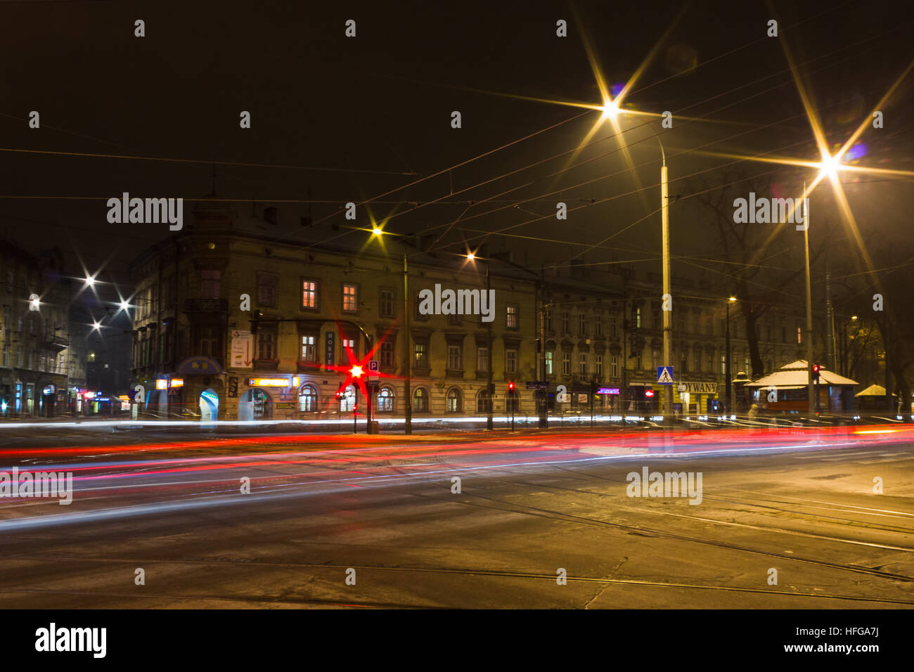 Traffic trails captured at a busy junction in Krakow at night. Stock Photo
