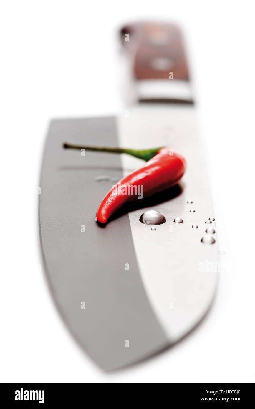 Hot pepper on knife Stock Photo Alamy