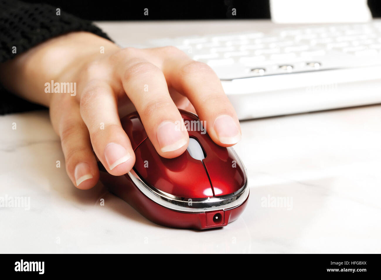 Female hand held over a computer mouse Stock Photo Alamy