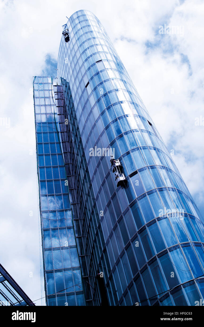 Window-cleaner cleaning the glass facade of a high-rise building, exterior Stock Photo