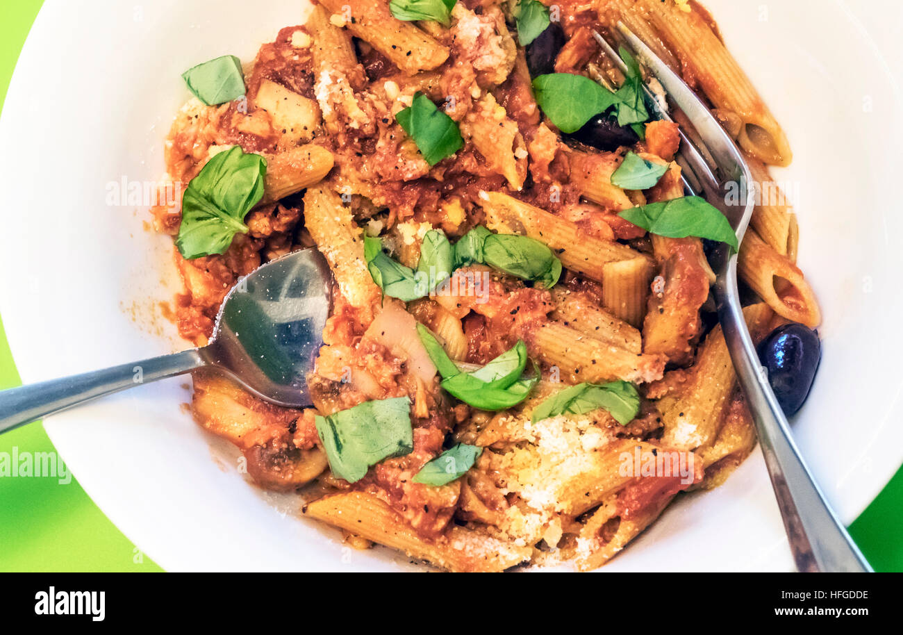 Penne pasta with mushrooms, olives, tomatoes, basil and Pecorino Romano