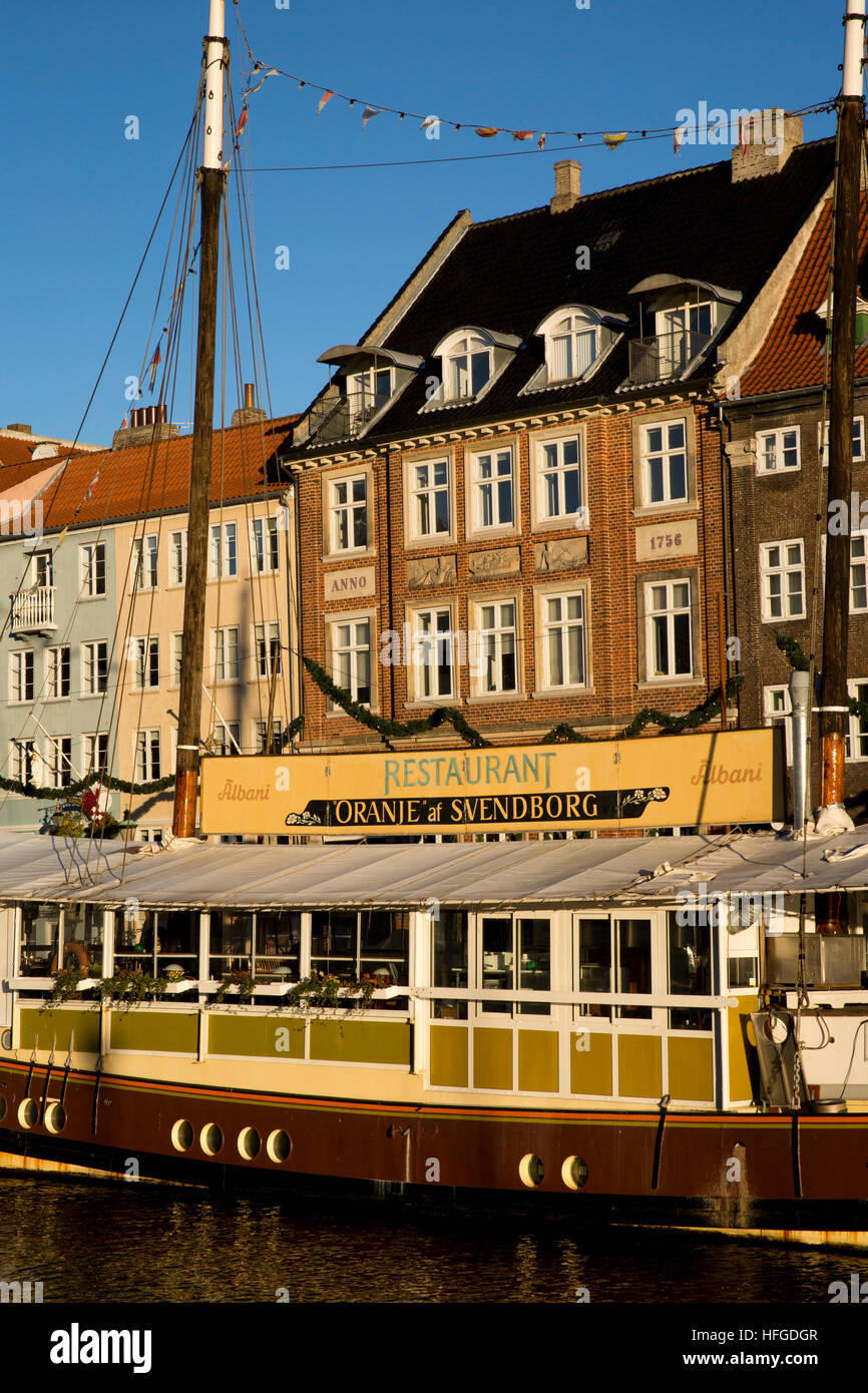 Denmark, Copenhagen, Oranje at Svenborg restaurant boat moored beside Nyhavn Quay Stock Photo