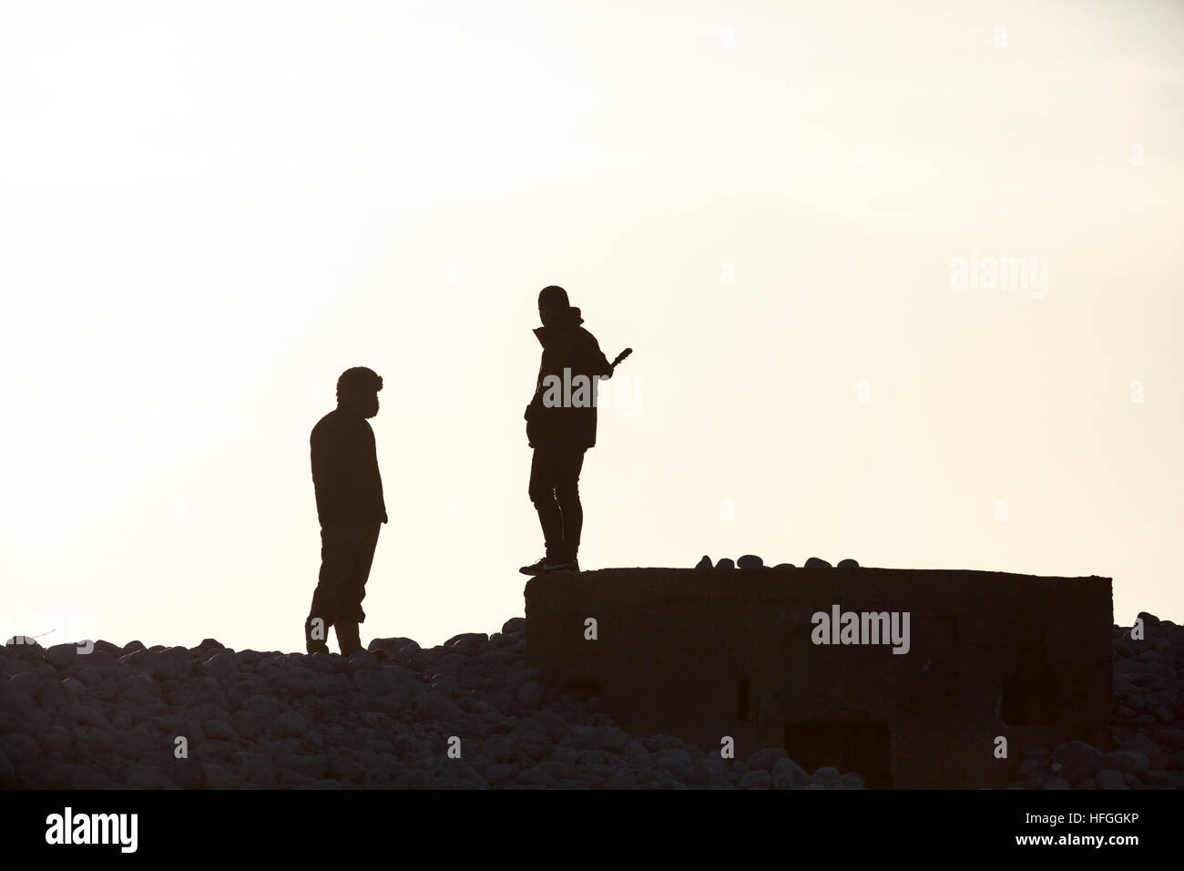 silhouette of two threatening adolescents Stock Photo
