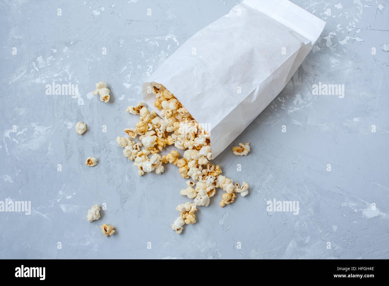 Sweet caramel popcorn in a paper bag on the concrete gray background Stock Photo Alamy