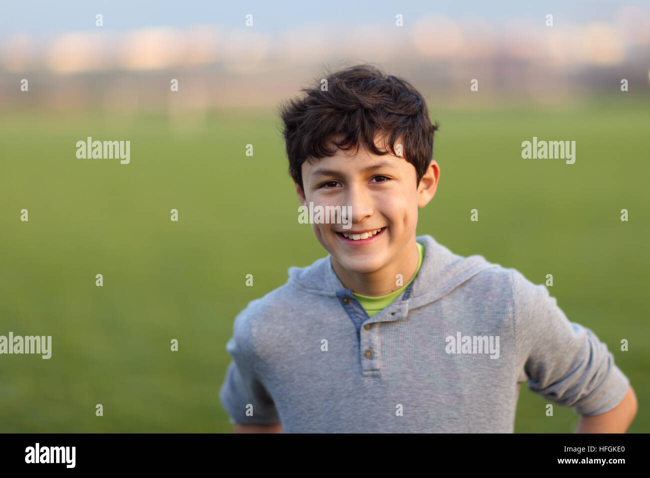 Young teen boy in the playing field during the golden hour - shallow depth of field Stock Photo