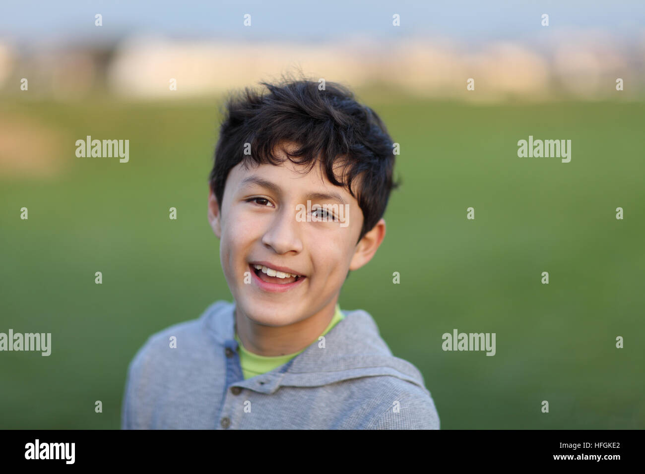 Young teen boy in the playing field during the golden hour - shallow depth of field Stock Photo