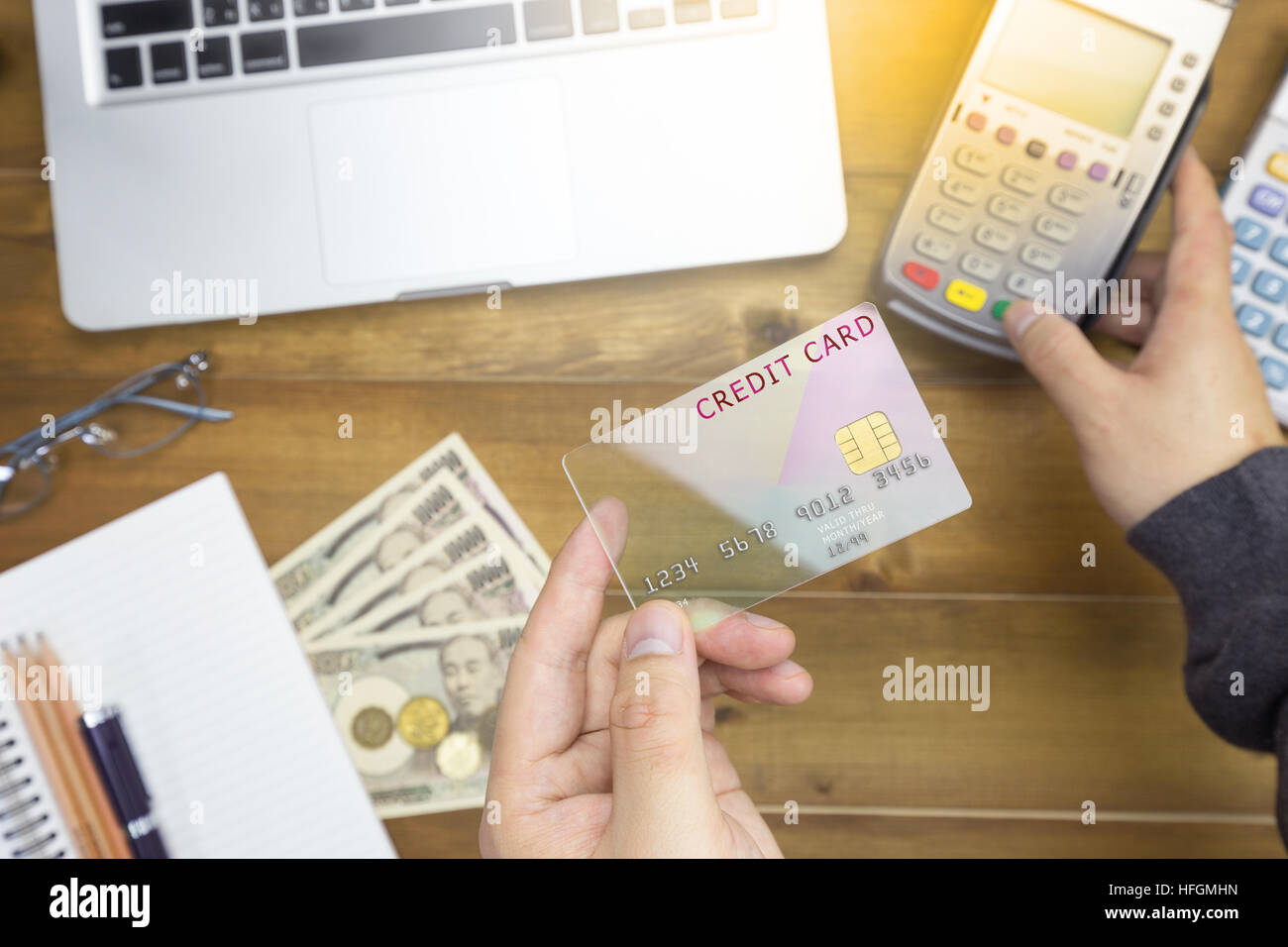Cashier hand holding a Credit card over EDC machine or credit card