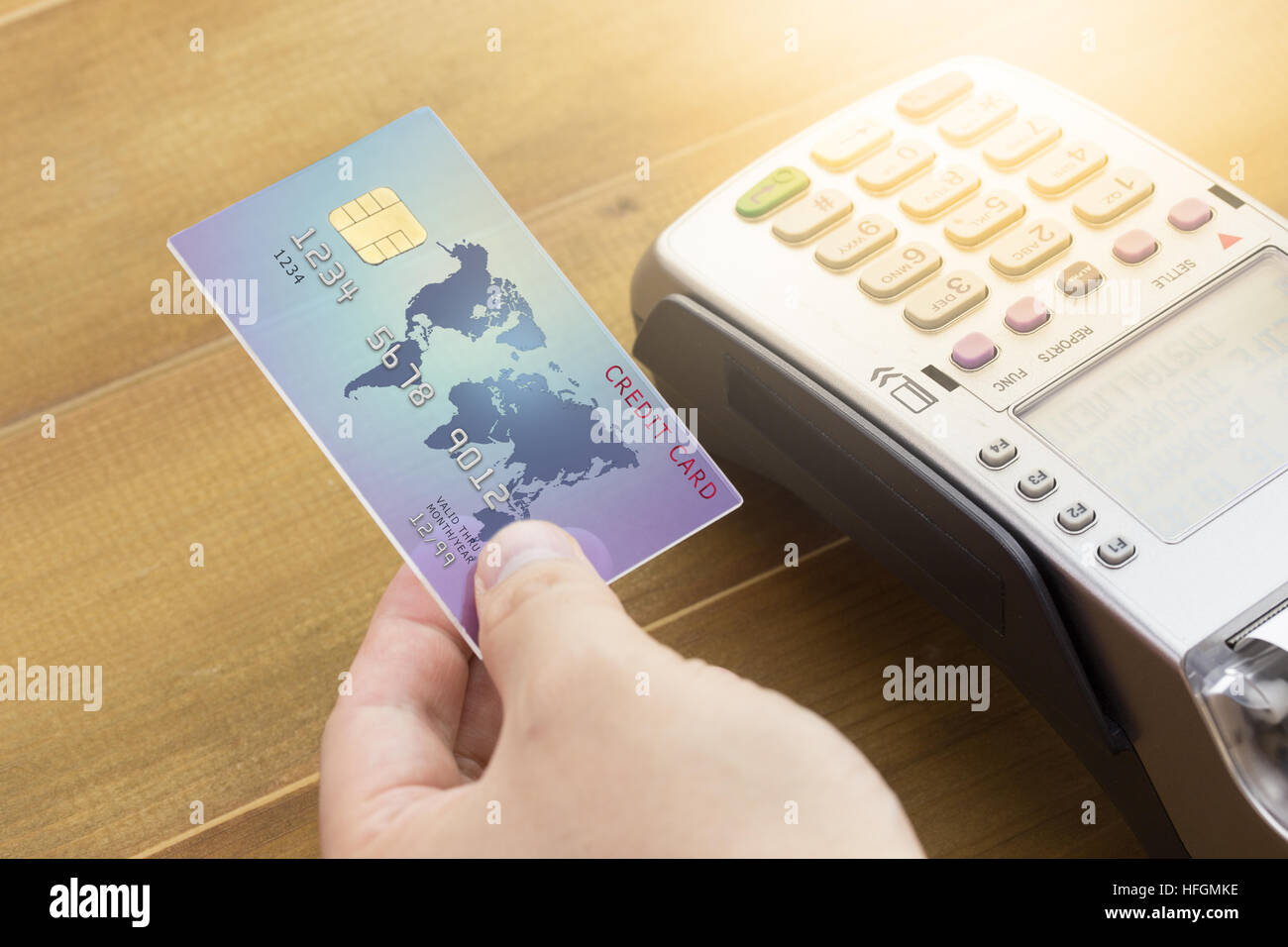 Cashier hand holding a Credit card and EDC machine or credit card