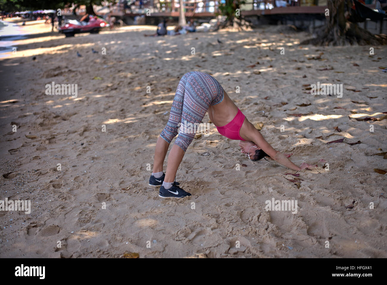 Woman beach exercise. Female keep fit exercising and working out on the beach at Pattaya Thailand S. E. Asia Stock Photo