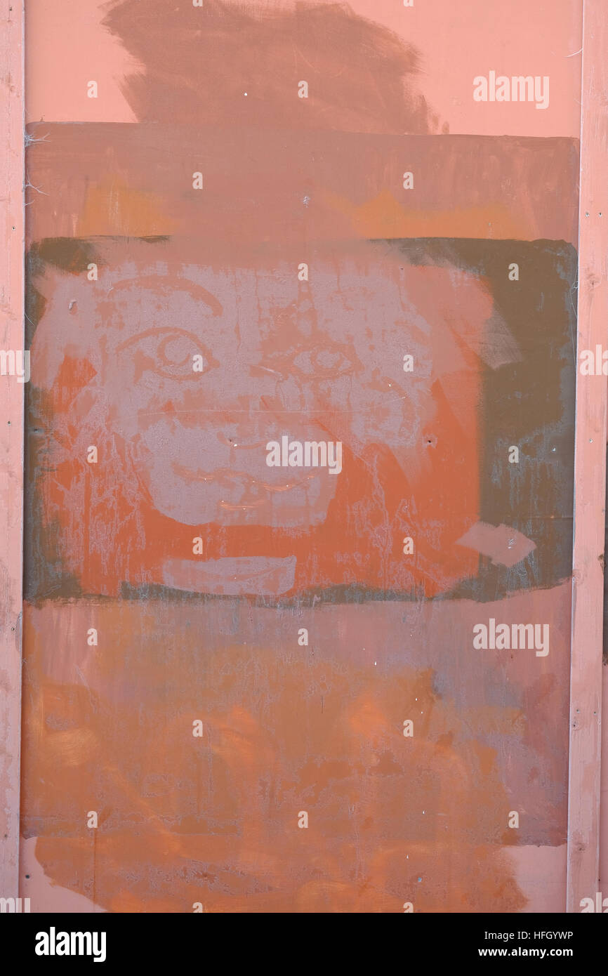 face painted on to a temporary wooden building-site hoarding Stock Photo