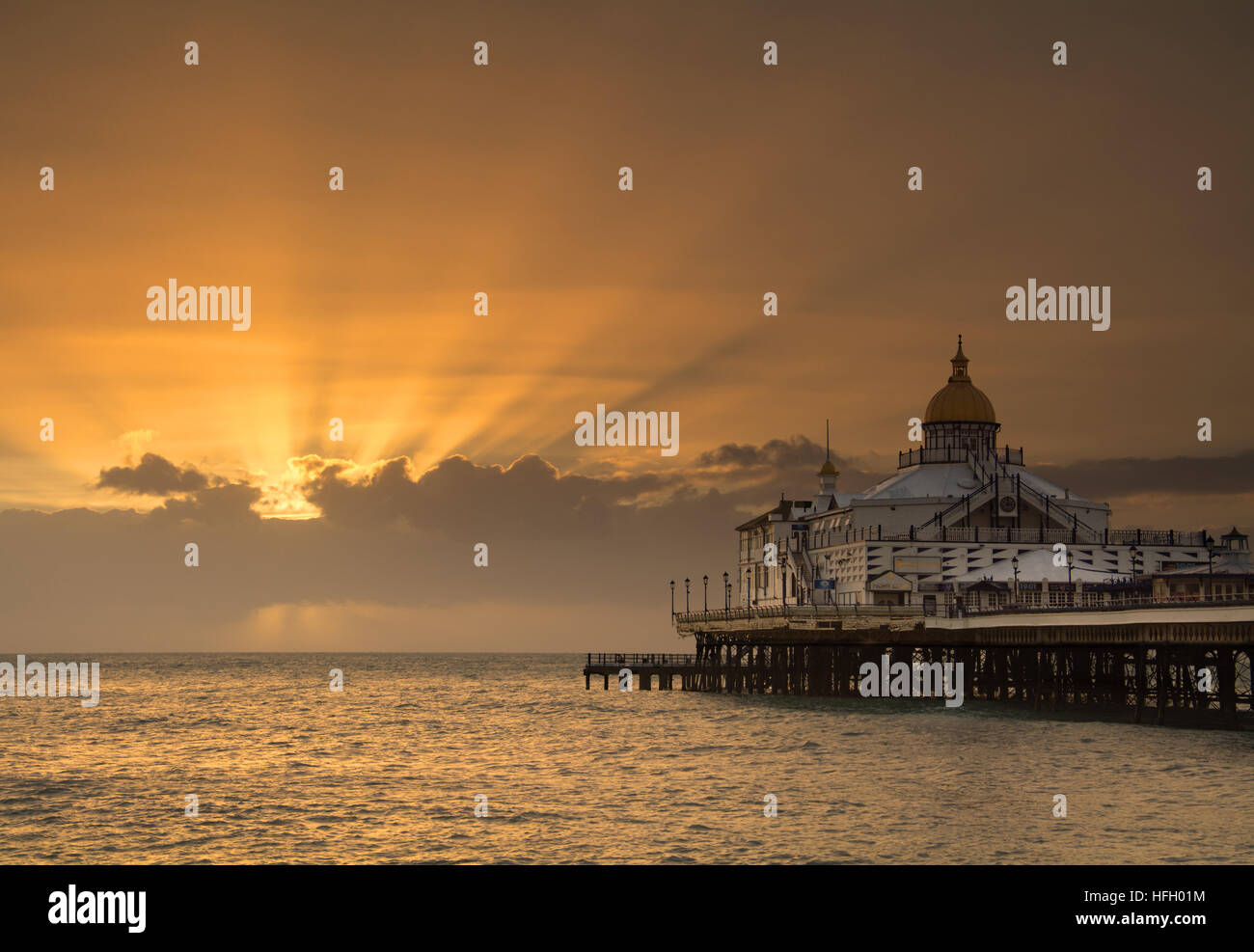 Sunrise and sunrays over Eastbourne Pier Stock Photo