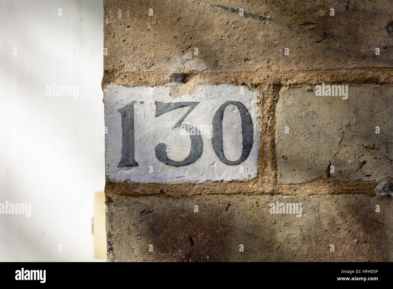 House Number 130 painted sign on wall Stock Photo - Alamy