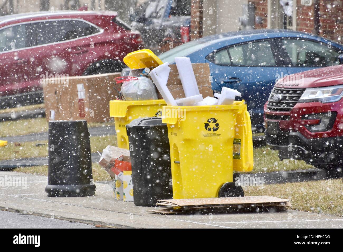 Hanover, Maryland, USA. 30th December, 2016. Trash and recycling bins lay out on street while they are being snowed on and blown over or across the road from the windy, cold, and snowy weather in Anne Arundel County Maryland. Credit: Jeramey Lende/Alamy Live News Stock Photo