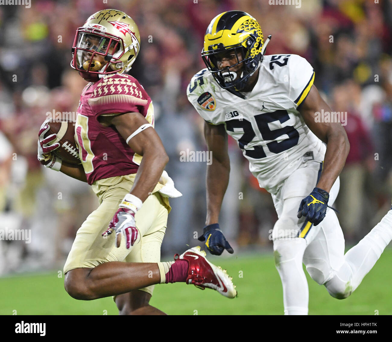 Miami Gardens, FL, USA. 30th Dec, 2016. Florida State Seminoles wide receiver Nyqwan Murray (80) breaks free on a 92-yard touchdown pass as Michigan Wolverines safety Dymonte Thomas gives chase. Florida State University vs. University of Michigan. 2016 Capital One Orange Bowl. Hard Rock Stadium, Miami Gardens, FL. 12/30/16. Staff Photographer Jim Rassol © Sun-Sentinel/ZUMA Wire/Alamy Live News Stock Photo