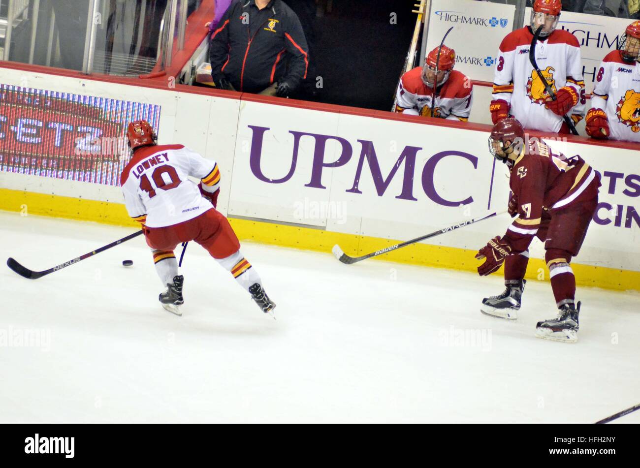 Boston College forward Chris Kreider (#19) salutes the team's fans by  hoisting the national championship trophy as he exists the rink after the  game. Boston College defeated Wisconsin 5-0 in the NCAA