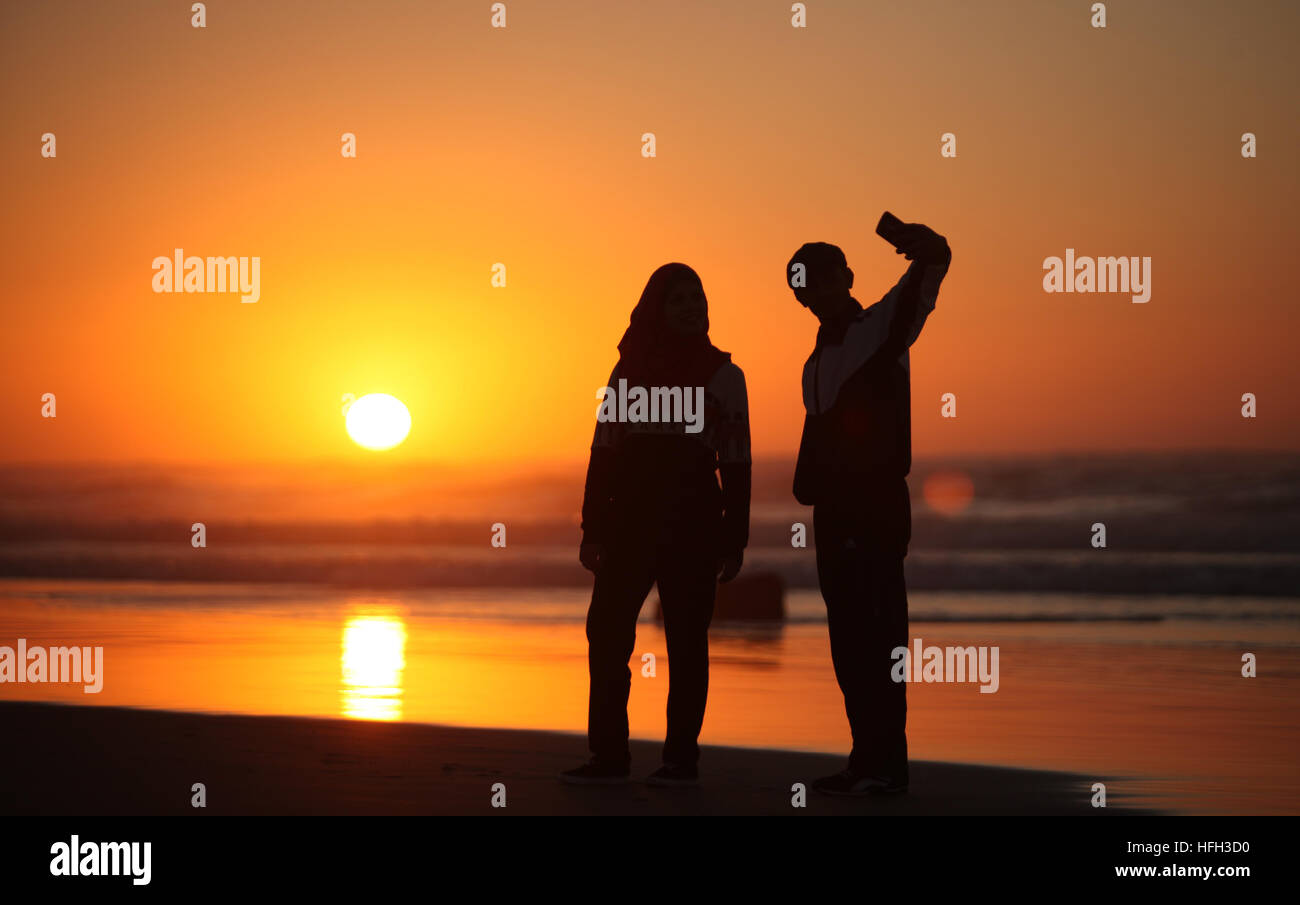 Gaza City, Gaza Strip, Palestinian Territory. 31st Dec, 2016. Palestinians take a selfie on the beach of Gaza City, during the last sunset of 2016, on December 31, 2016 © Ashraf Amra/APA Images/ZUMA Wire/Alamy Live News Stock Photo