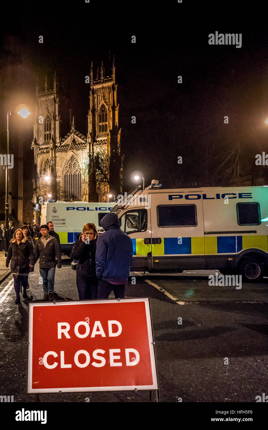 York, UK. 31st December, 2016. New Year’s Eve revellers congregate at York Minster to celebrate the start of 2017. In the wake of the recent terror truck attack in Berlin, Police used vans to block off vehicle access to the Minster, and an armed contingent of officers attended the event. Photo Bailey-Cooper Photography/Alamy Live News Stock Photo