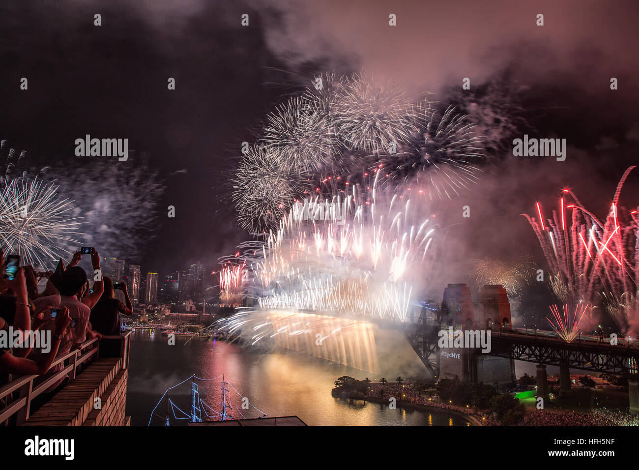 Sydney, Australia. 31st Dec, 2016. People watch the New Year's Eve fireworks from rooftops and parks. Credit: Nick Williamson/Alamy Live News Stock Photo
