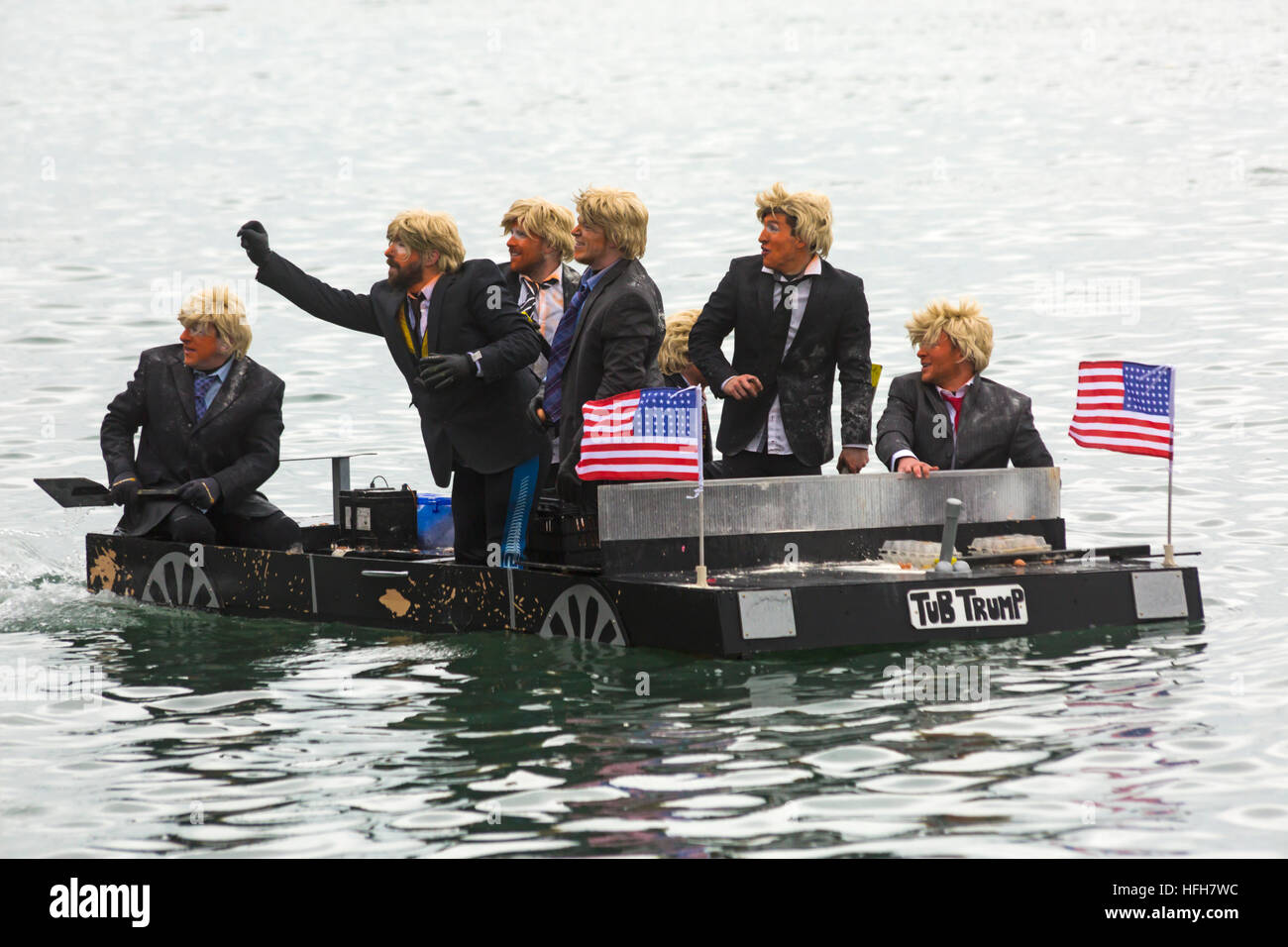 Poole, Dorset, UK. 1st Jan, 2017. Hundreds turn out to watch the New Years Day Bath Tub Race. A variety of unusual craft take to the water to race, having fun throwing eggs and flour, firing water cannons and capsizing competing craft. Trumps with wigs hair and make up in Tub Trump © Carolyn Jenkins/Alamy Live News Stock Photo