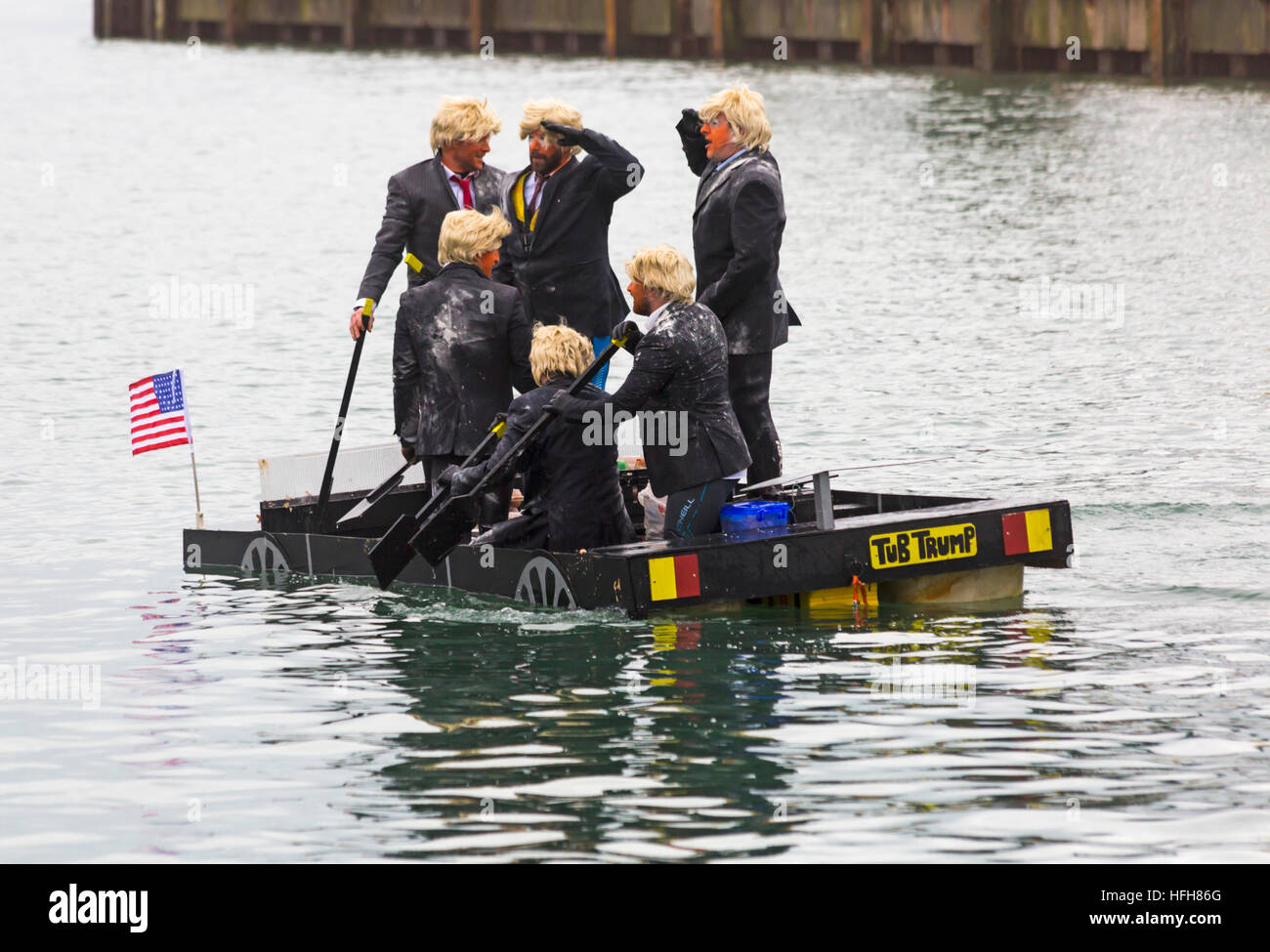 Poole, Dorset, UK. 1st Jan, 2017. Hundreds turn out to watch the New Years Day Bath Tub Race. A variety of unusual craft take to the water to race, having fun throwing eggs and flour, firing water cannons and capsizing competing craft. Trumps with wigs hair and make up in Tub Trump © Carolyn Jenkins/Alamy Live News Stock Photo