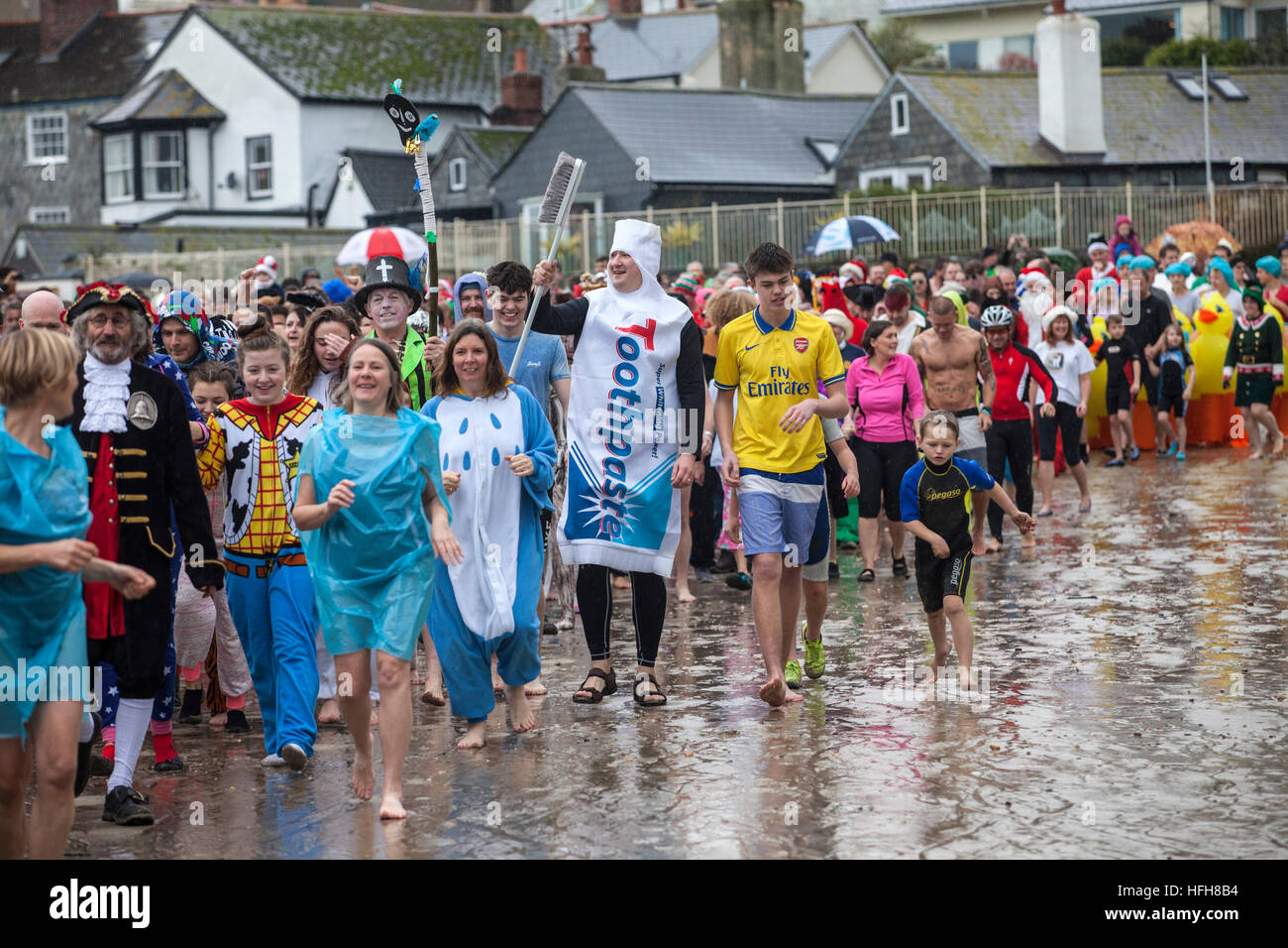 Hundreds turned out in fancy dress despite the rain to take part in the 'Lyme Lunge' - a New Year's Day swim in Lyme Regis 2016 Stock Photo