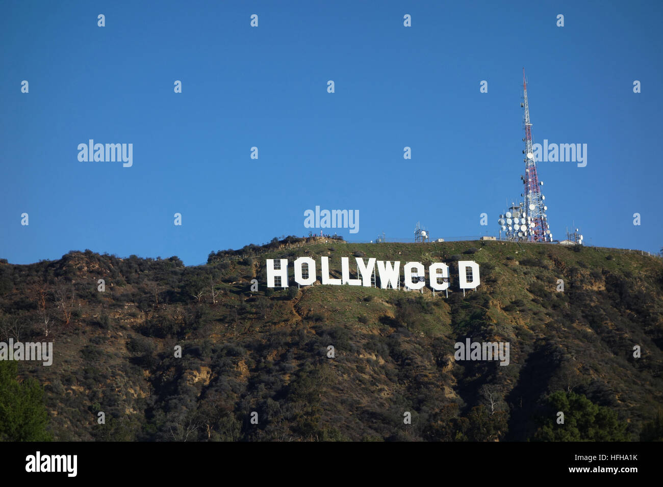 Hollywood, USA. 1st January 2017. The iconic Hollywood Sign was altered by pranksters to read 'Hollyweed'.  Residents nearby the sign awoke to this view on New Year's Day. The iconic sign was similarly altered once before on Jan. 1, 1976. Credit: Robert Landau/Alamy Live News Stock Photo