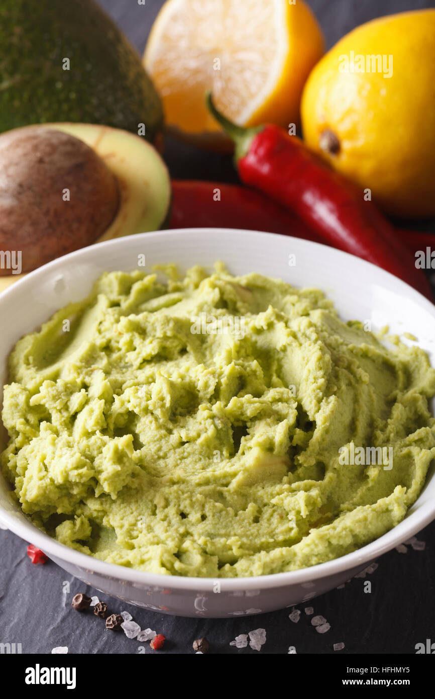 Mexican green guacamole sauce in a bowl macro. Vertical Stock Photo Alamy