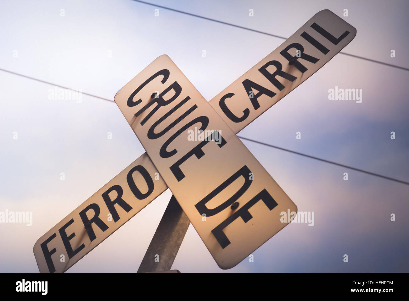 Photograph of a railroad crossing sign in spanish Stock Photo Alamy