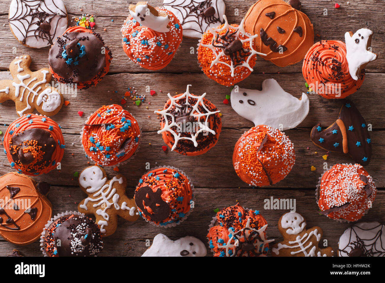 Halloween cupcakes and gingerbread cookies on the table. horizontal view from above Stock Photo