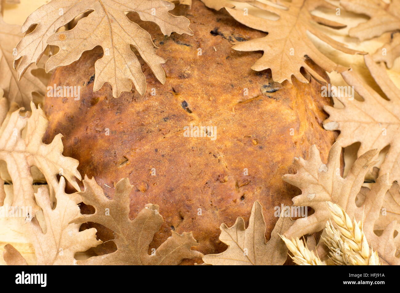 Orthodox Christmas bread covered with Yule log dry leaves Stock Photo